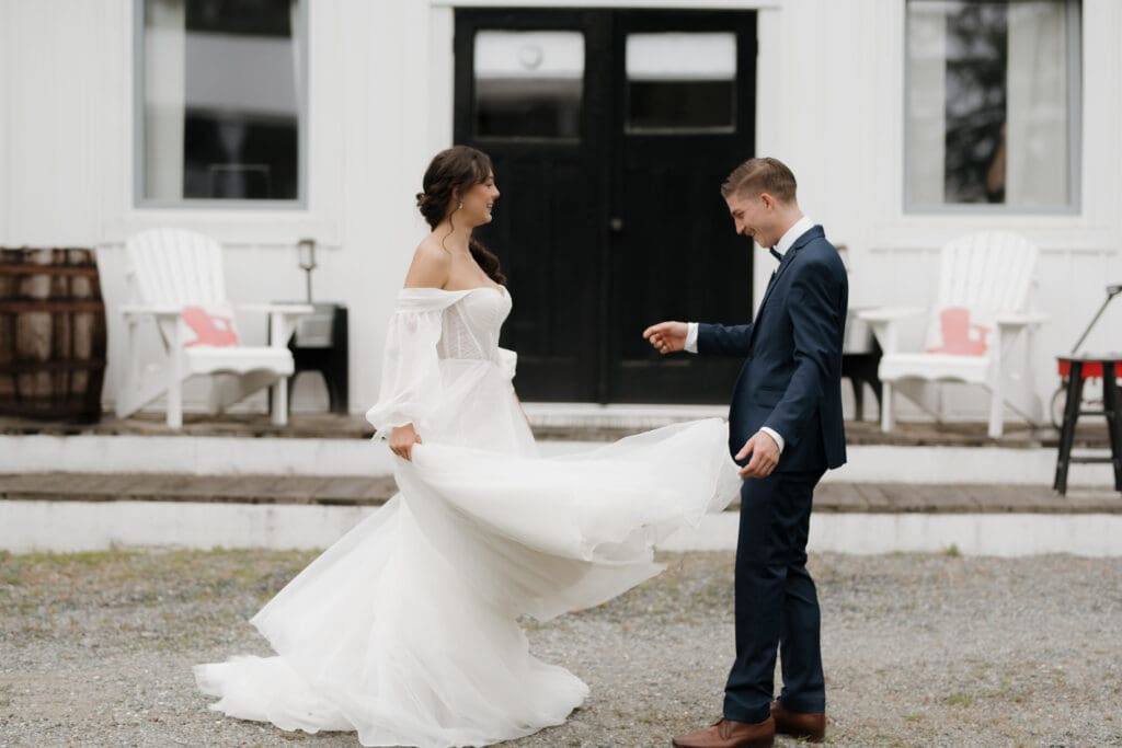 Hayley Zumkeller photography and videography team from Victoria BC capture a bride and groom during their first look. The stunning bride in her whimsical, flowy dress finishes a spin for her smiling husband to be. Puska Properties on Vancouver Island in BC provided the perfect location for this outdoor wedding.