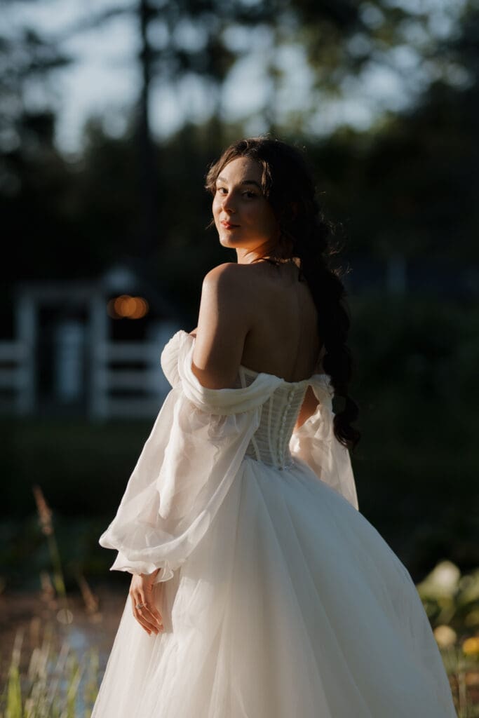Hayley Zumkeller photography and videography team capture a bride with the golden hour rays filtering through the trees in the background at Puska Properties in Nanaimo on Vancouver Island.