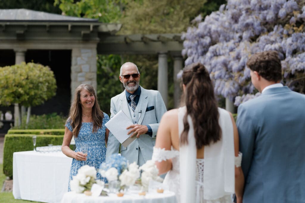 Hatley Castle Wedding in Victoria BC captured by local Wedding Photographer Hayley Zumkeller - Wedding Cocktail Hour and Reception taking place in the Italian Gardens where the couple is doing a champagne toast