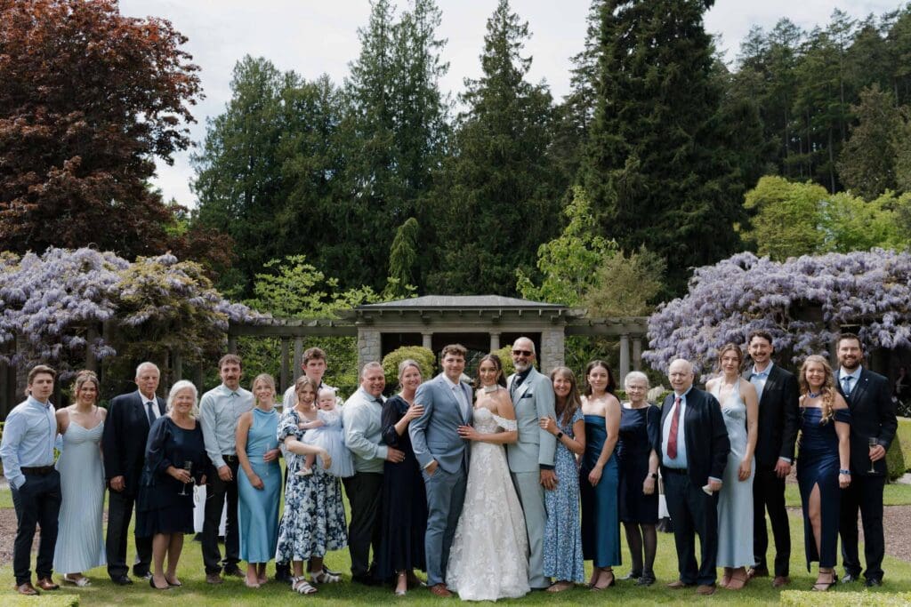 Hatley Castle Wedding in Victoria BC captured by local Wedding Photographer Hayley Zumkeller - Wedding Cocktail Hour and Reception taking place in the Italian Gardens where the couple is doing a champagne toast