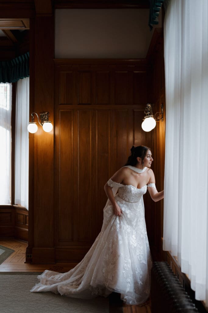 Hatley Castle Wedding in Victoria BC captured by local Wedding Photographer Hayley Zumkeller indoors while the bride was getting ready and putting on her scarf