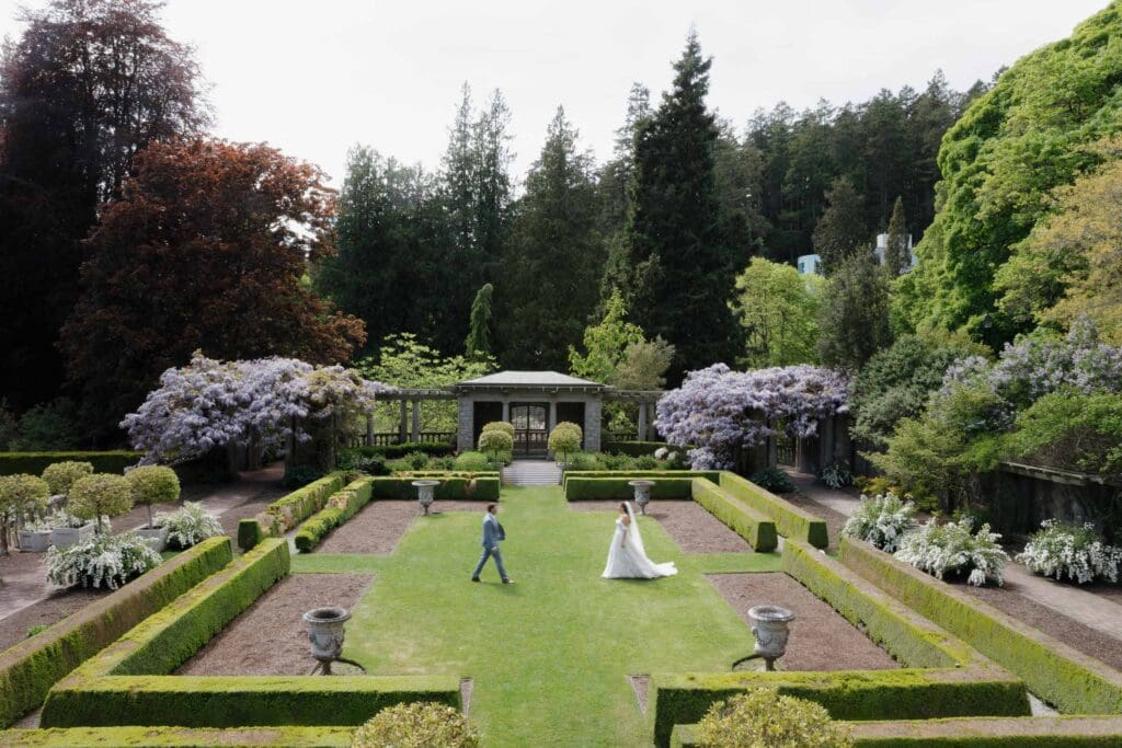 Couple running in the grass at Hatley Caslte - local Victoria BC Wedding Photographer captures wedding photos at Hatley Castle Wedding in BC