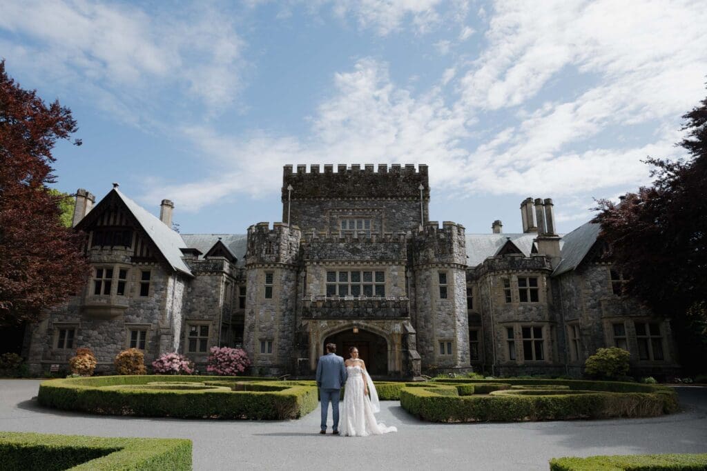 Hatley Castle Wedding Photography of couple who just got married standing at the front of the castle taken by hayley zumkeller photography