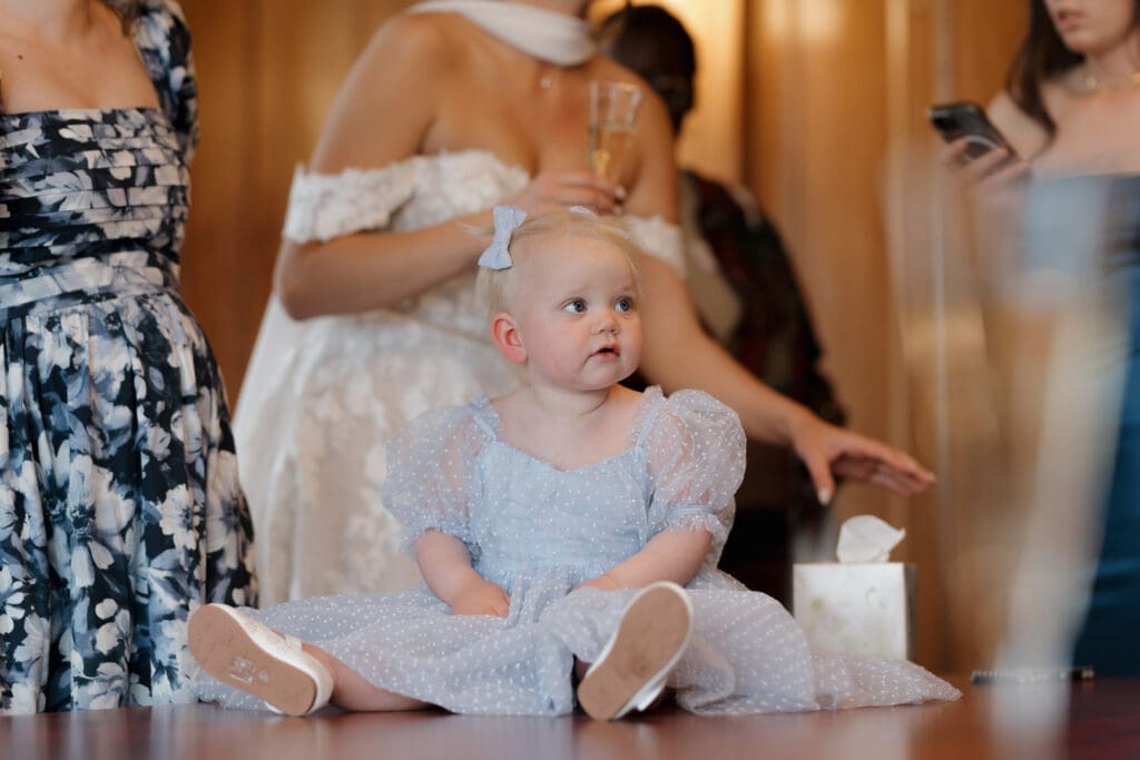 Hayley Zumkeller photography and videography team from Victoria BC capture an infant girl dressed in a pale blue dress before the ceremony at Hatley Castle on Vancouver Island.