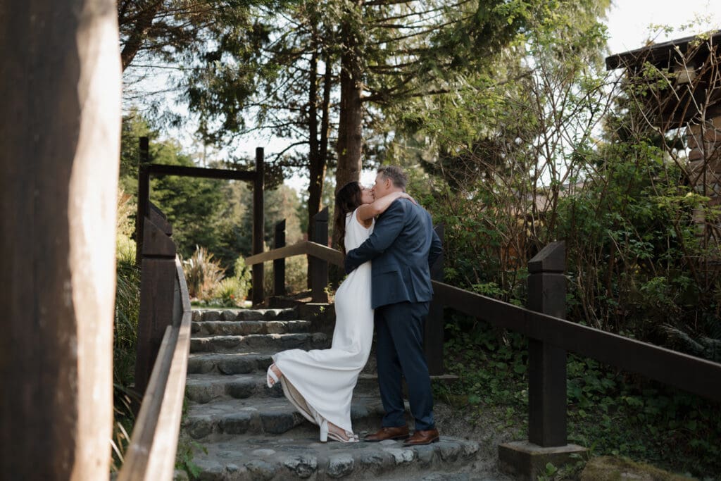 Hayley Zumkeller photography and videography team capture an image of a groom and his bride embracing following their first look prior to their elopement on Chesterman Beach on Vancouver Island in BC.