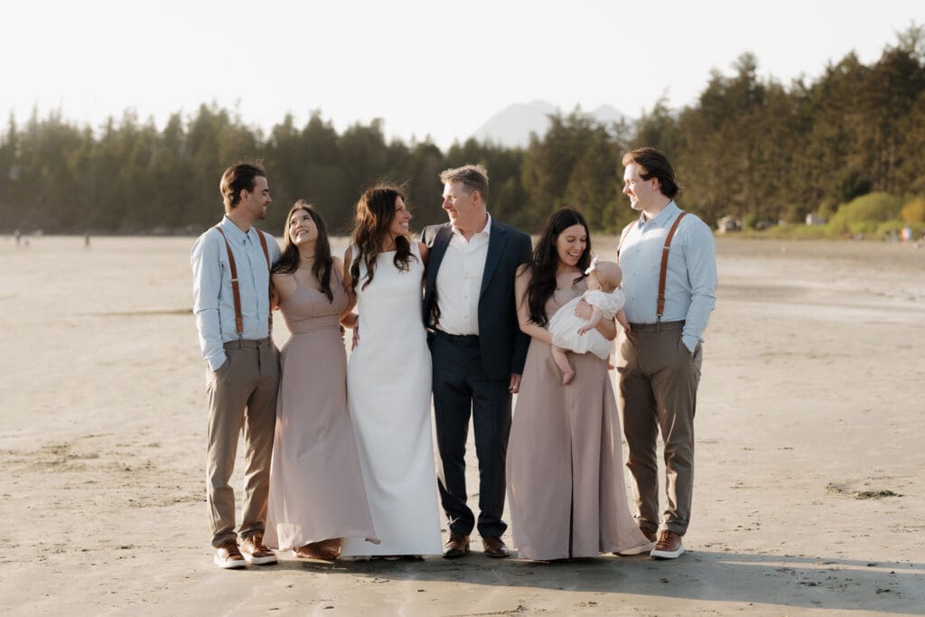 Tofino BC Wedding Photographer and Videographer captures bride and groom, and their family on Chesterman Beach. Sunset Wedding Photogrpahy at Chesterman Beach with the Bride and Groom at Golden Hour in Tofino