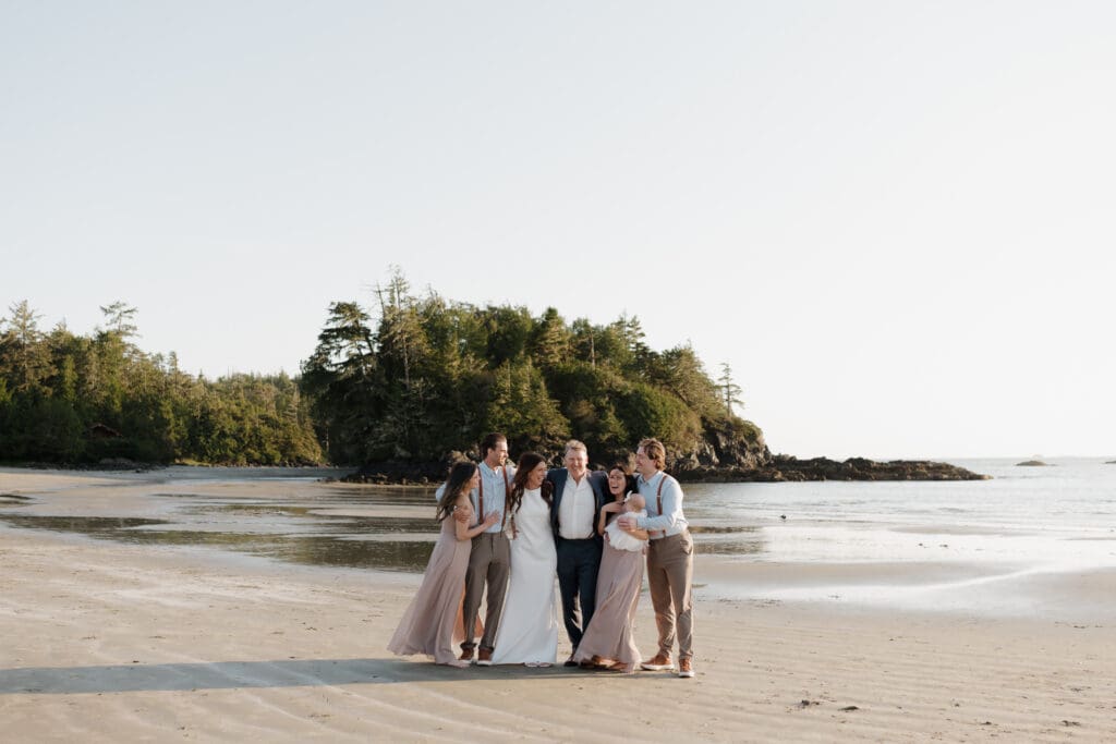 Tofino BC Wedding Photographer and Videographer captures bride and groom, and their family on Chesterman Beach. Sunset Wedding Photogrpahy at Chesterman Beach with the Bride and Groom at Golden Hour in Tofino
