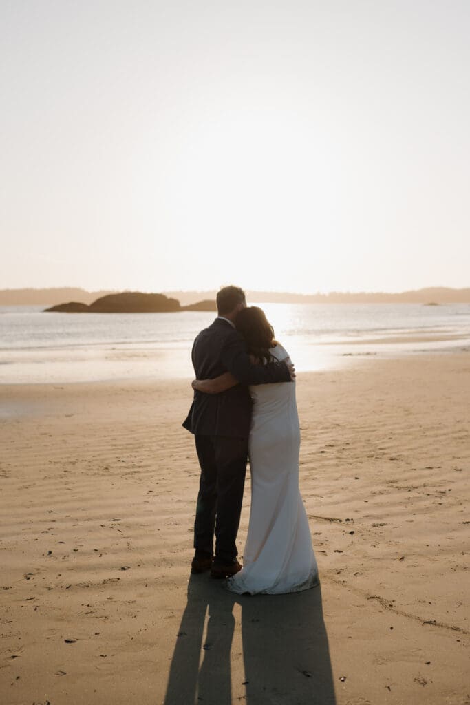 Tofino BC Wedding Photographer and Videographer captures bride and groom, and their family on Chesterman Beach. Sunset Wedding Photogrpahy at Chesterman Beach with the Bride and Groom at Golden Hour in Tofino