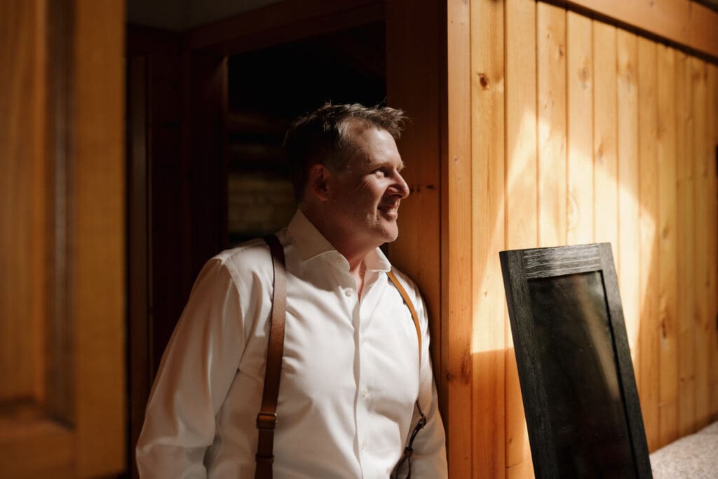 Groom getting ready in Crystal Cove Cabin for his Tofino BC Wedding. Local Tofino BC Wedding Videography Team - Hayley Zumkeller - capture moments on both photo and video.