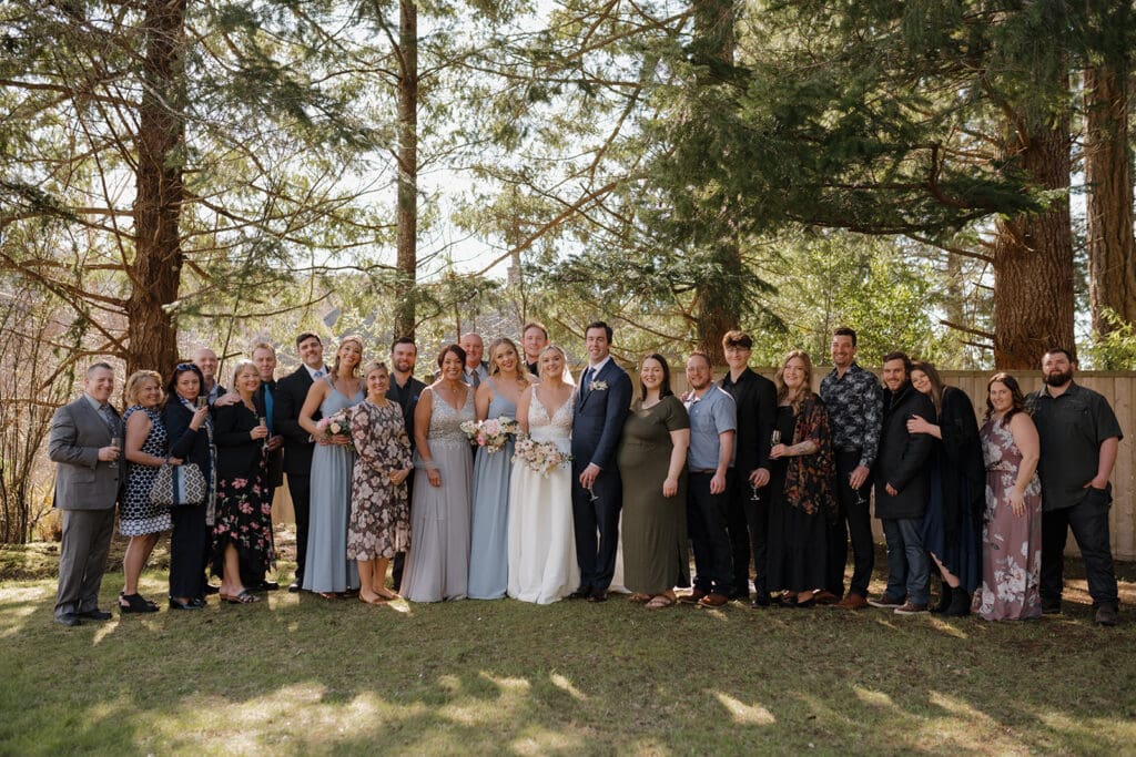 Hayley Zumkeller Victoria BC Wedding Photographer and Filmmaker captures a large extended family portrait with a forest backdrop at a Gowlland Harbour luxury wedding.