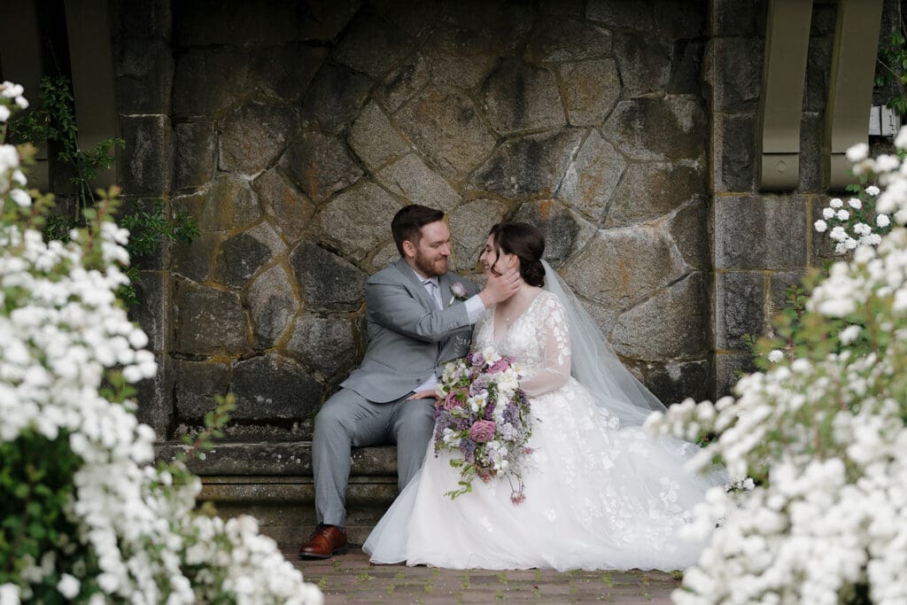 Hayley Zumkeller Victoria BC Wedding Photographer and Videographer captures an intimate moment between a wedding couple among the historical grounds at Hatley Castle. 