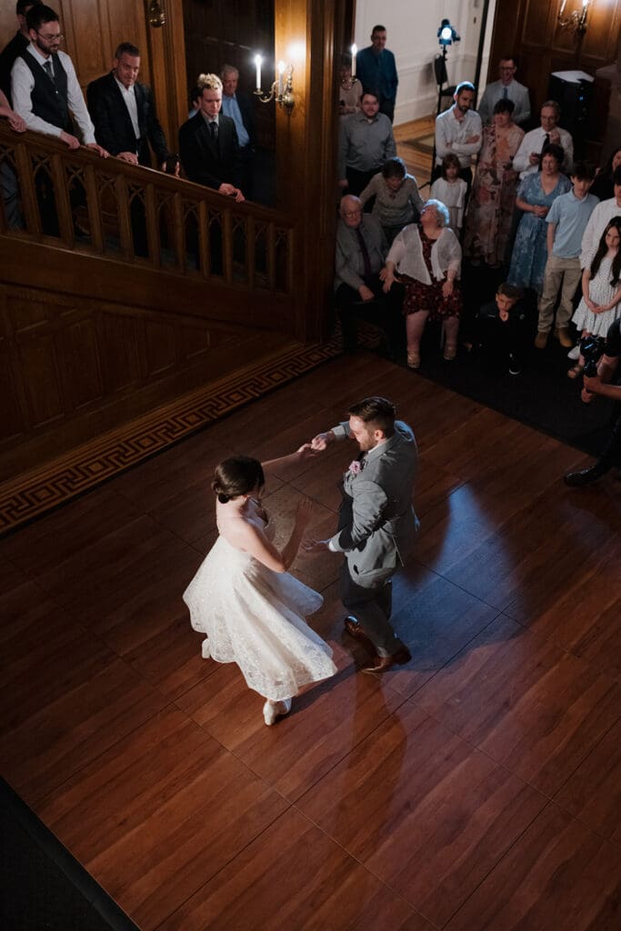 Hayley Zumkeller, Victoria BC Wedding Photographer and Videographer, captures the groom spinning the bride during their fun first dance inside Hatley Castle.