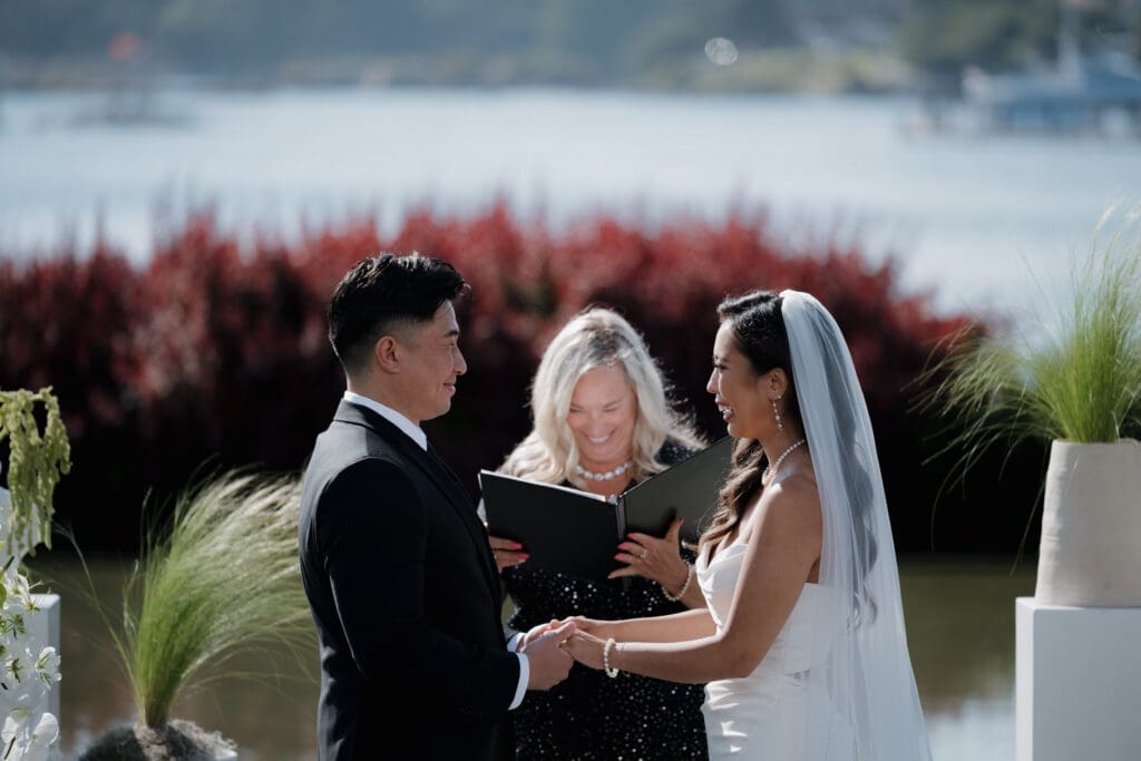 A BC officiant performs the wedding ceremony of a bride and groom on Vancouver Island. Image captured by the talented Hayley Zumkeller photography and videography team from Victoria BC.