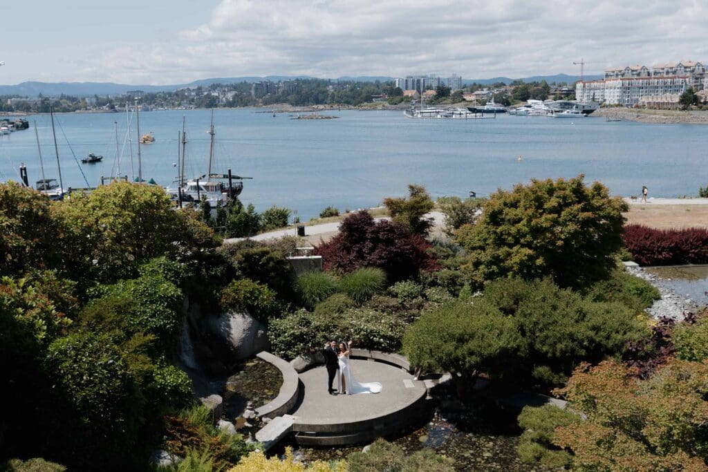 Hayley Zumkeller, Victoria BC Wedding Videography and Photography team capture a distance shot, thanks to her team, of the first look between a bride and groom at Laurel Point Inn during a mini-destination on Vancouver Island.