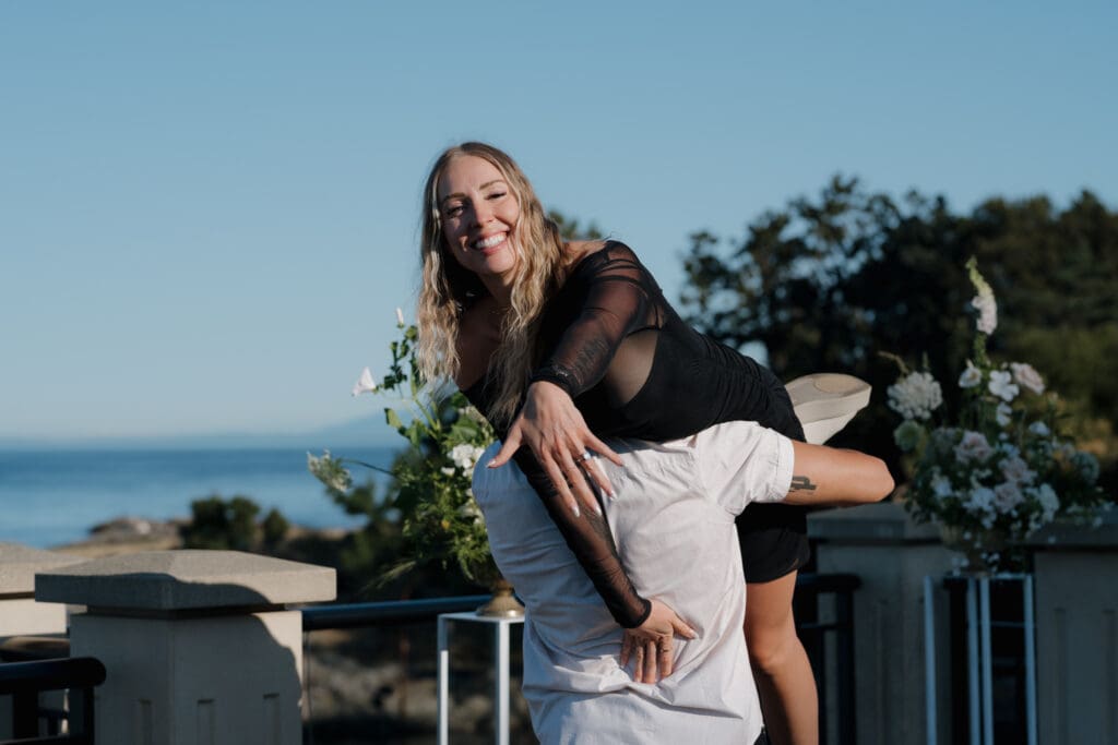 Hayley Zumkeller Photography and Videography team capture a couple embracing in front of Oak Bay Beach Hotel in Victoria BC after a surprise proposal.
