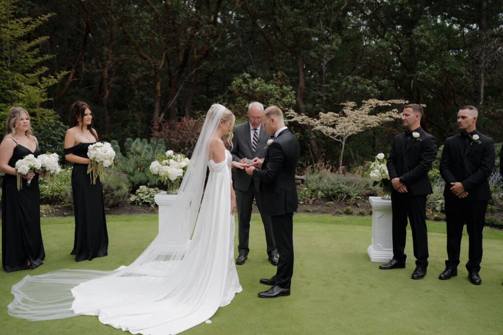 Hayley Zumkeller photography and videography team from Victoria BC capture the bride and groom exchanging rings during the ceremony.
