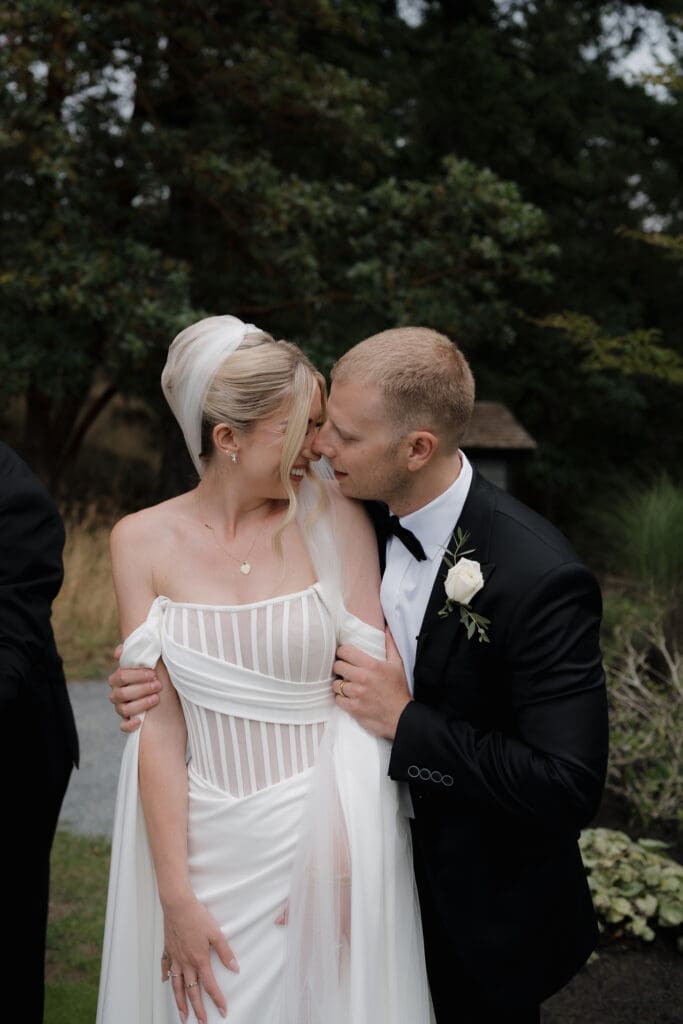 Hayley Zumkeller photography and videography team capture a newly married husband and wife as they share an intimate embrace and giggle, realizing they are now married.