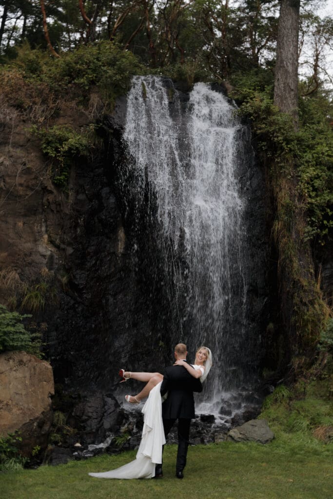Hayley Zumkeller photography and videography team capture a bride and groom at the waterfall at Olympic View golf course on Vancouver Island.