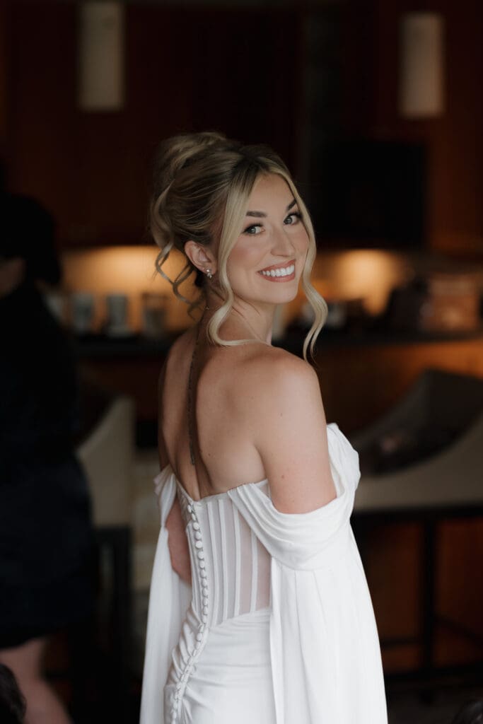 Hayley Zumkeller photography and videography team from Victoria BC capture a bride to be as she finishes getting ready. Her modern, Grecian-inspired gown gave her a regal elegance, perfectly complemented by her hair and makeup team’s soft, romantic styling.
