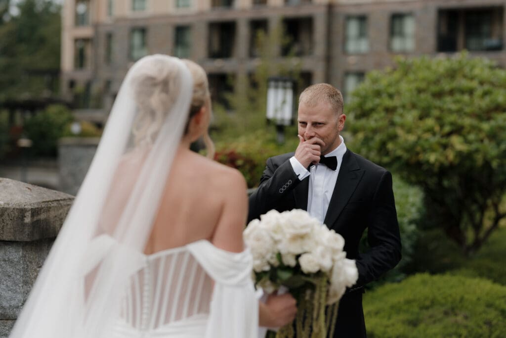 Hayley Zumkeller photography and videography team from Victoria BC capture the first look moment between a bride and groom. The groom turns and sees his bride for the first time, tears in his eyes and overcome by his emotions.