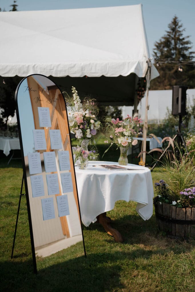 Hayley Zumkeller photography & videography team from Victoria BC capture a seating chart and guest sign in table arranged by a wedding planner on Vancouver Island.