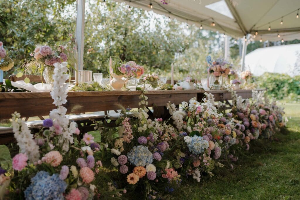 Hayley Zumkeller photography and videography team from Victoria BC capture the stunning floral arrangement for this outdoor reception on Vancouver Island.
