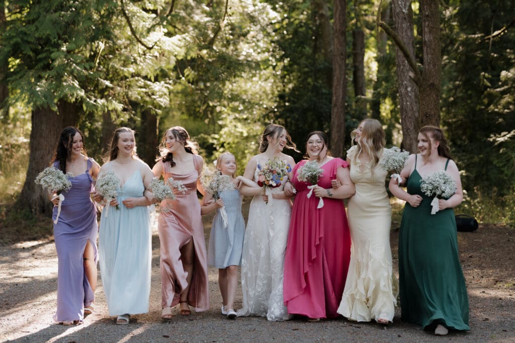 A gorgeous bride with her bridesmaids in their pastel gowns posing for photos prior to the wedding ceremony in Victoria BC. Image captured by Hayley Zumkeller photography and videography.