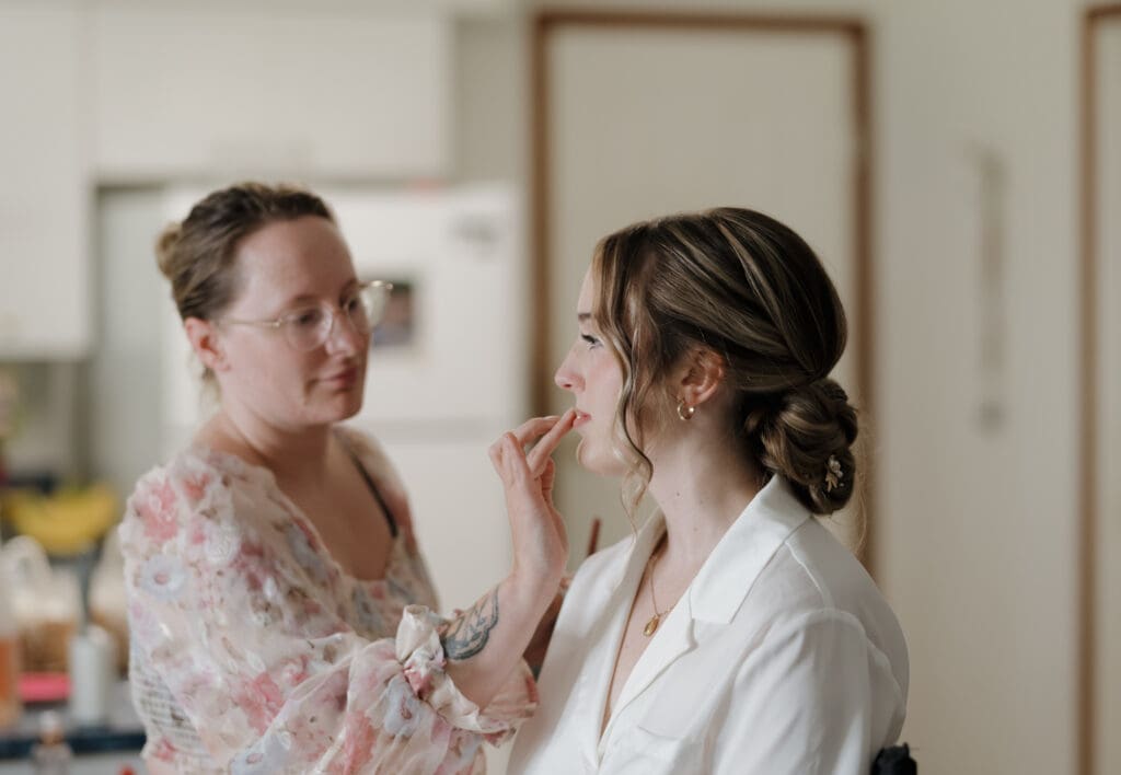A bride pre-wedding ceremony getting ready for the day with make-up being applied by a Victoria BC make-up artist. Image captured by Hayley Zumkeller photography and videography team from Vancouver Island.