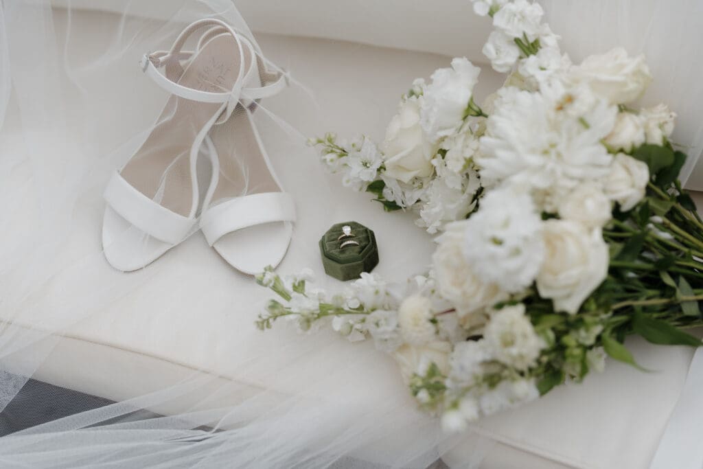 Hayley Zumkeller photography and videography team capture a floral bouquet along with the bride's accessories at a Victoria BC wedding.