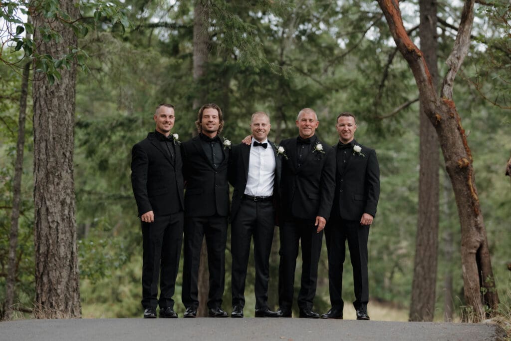 A handsome groom with this groomsman posing for photos in their tuxedos prior to the wedding day in Victoria BC. Image captured by Hayley Zumkeller photography and videography.