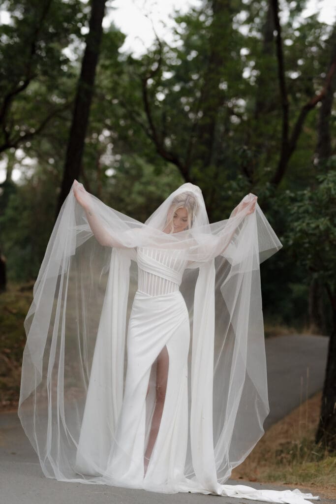 Hayley Zumkeller photography and videography from Victoria BC captures a bride showcasing her full, elegant wedding gown and veil at Olympic View Golf Course.