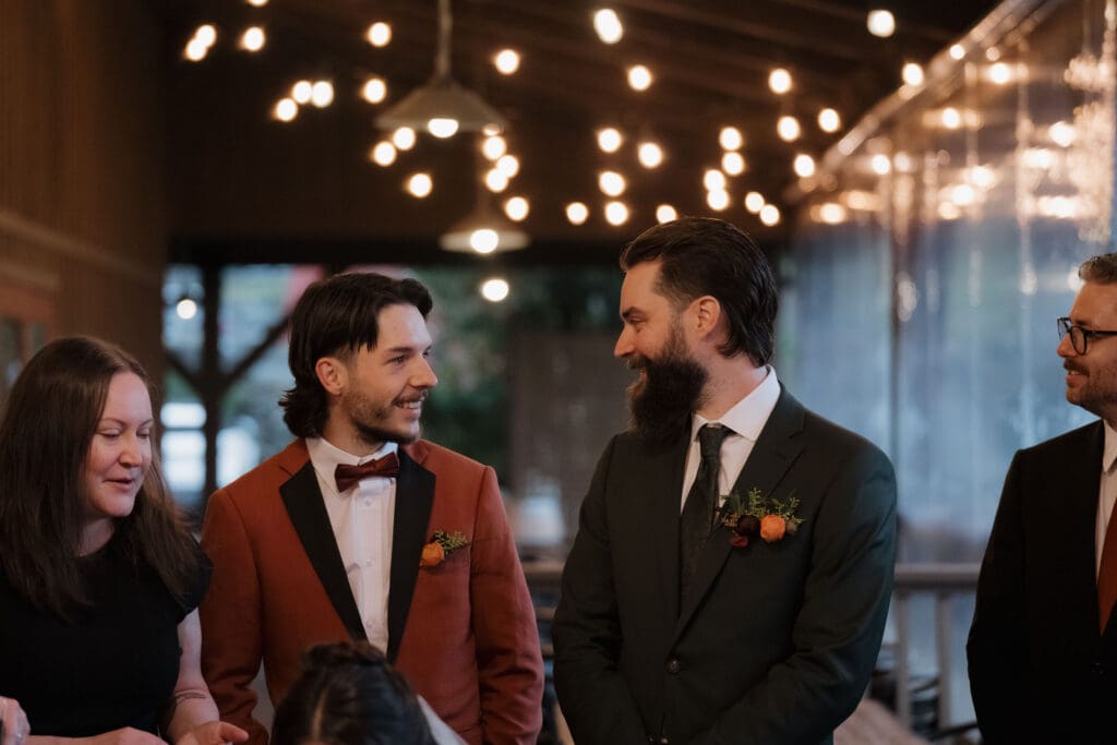 Hayley Zumkeller photography and videography team from Victoria BC captures a groom with his new brother in law following the wedding ceremony at Church and State Winery on Vancouver Island.