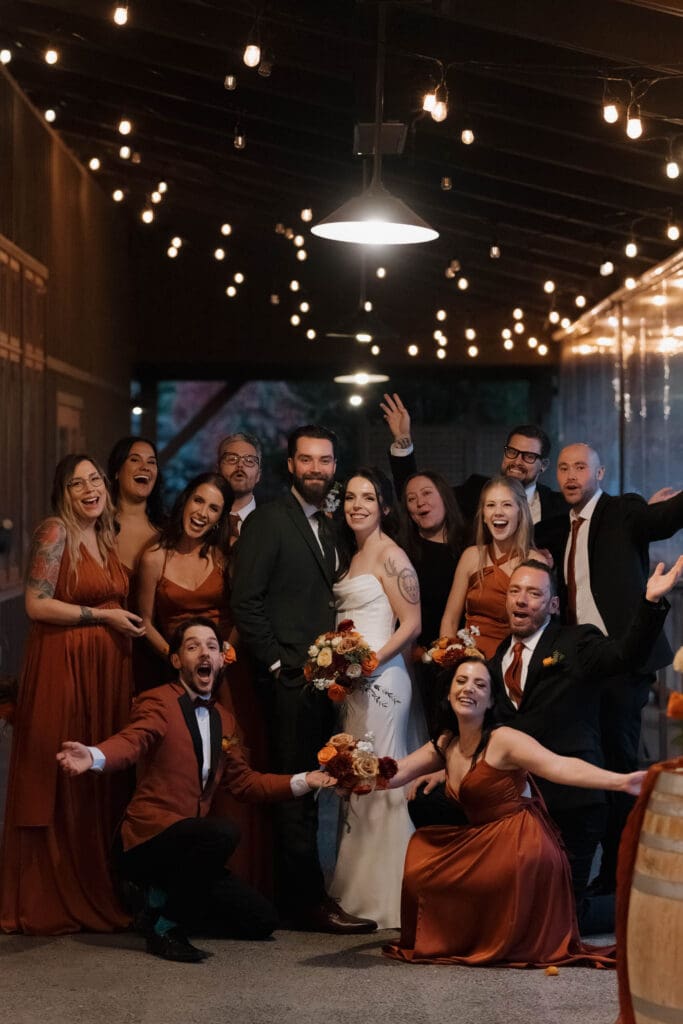 Hayley Zumkeller photography and videography team from Victoria BC capture the wedding party - dressed in deep oranges for the fall wedding - during the reception dance party at Church and State on Vancouver Island.