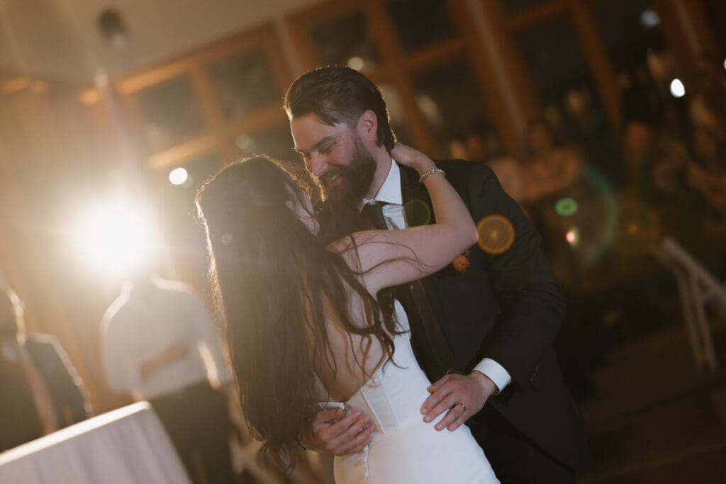 Hayley Zumkeller photography and videography team from Victoria BC captures an emotional first dance between a bride and groom during their reception at Church and State Winery on Vancouver Island. The look in the groom's eyes as he looks at his new bride is filled with love.