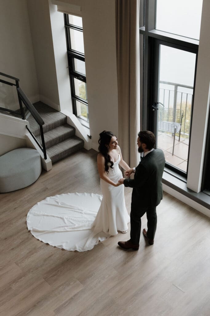 Bride and groom first look in hotel suite at Delta Ocean Pointe overlooking the ocean in Victoria BC