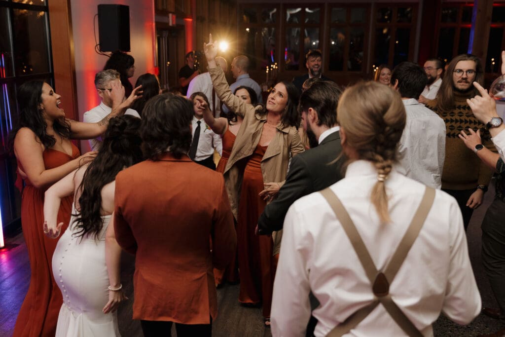 A group of friends are captured dancing and having a great time during this Church and State Winery Wedding reception. Image taken by Hayley Zumkeller photography and videography team from Victoria BC. 