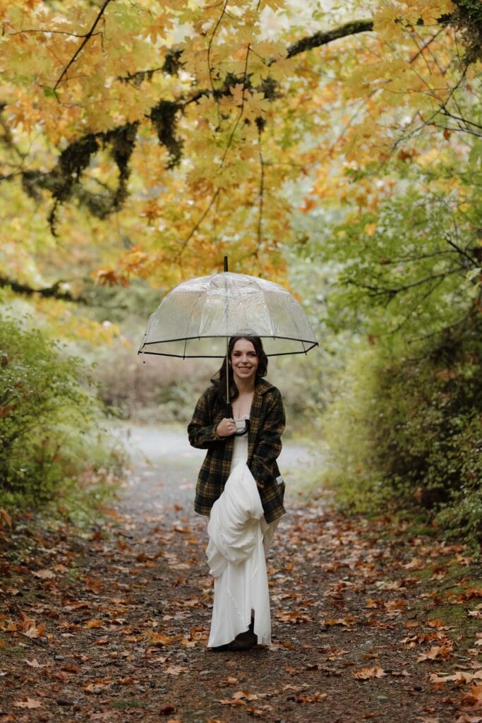 Couple sharing private vows in Vancouver Island forest in the rain surrounded by fall colours