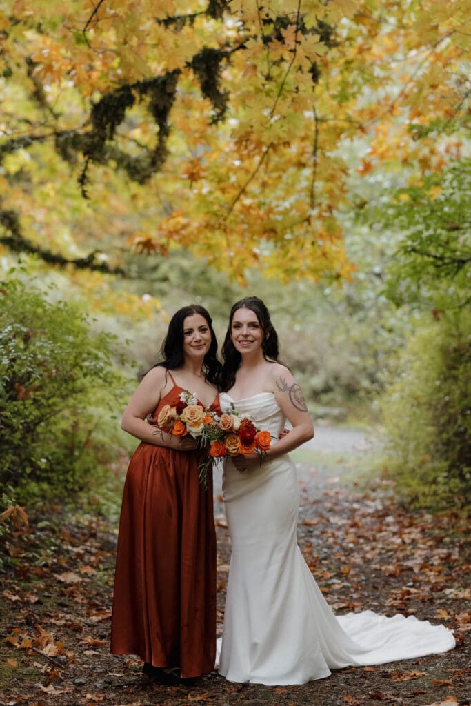 Couple sharing private vows in Vancouver Island forest in the rain surrounded by fall colours