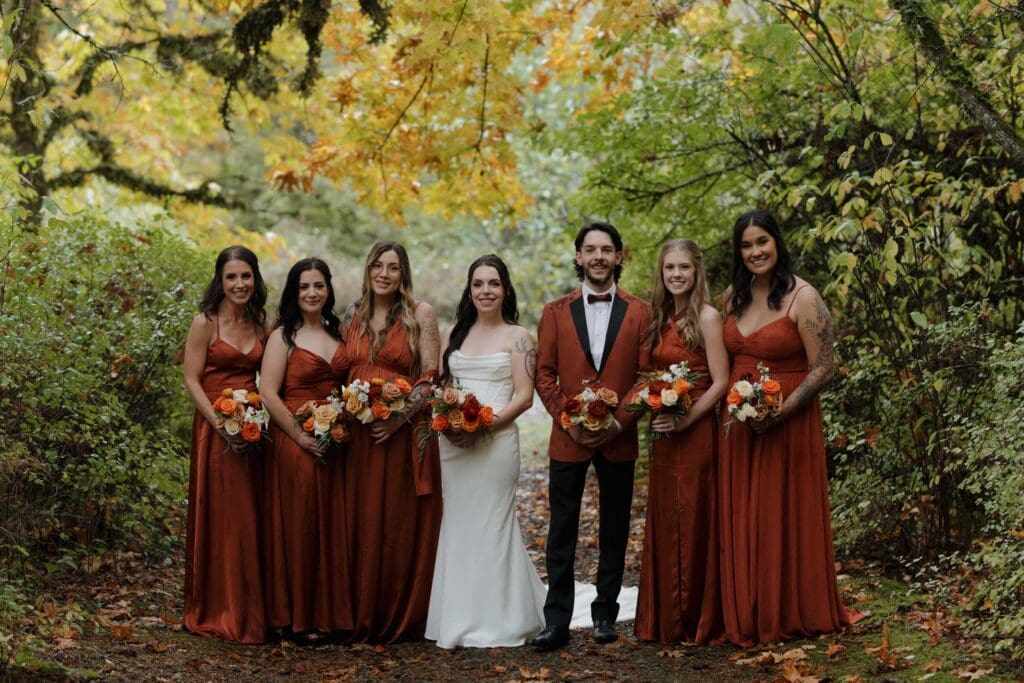 Hayley Zumkeller photography and videography team from Victoria BC capture a wedding party surrounded by the forest during this Fall wedding at Church and State Winery on Vancouver Island.
