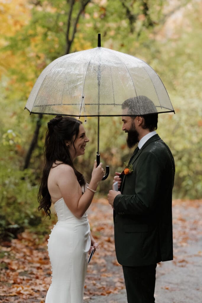 Hayley Zumkeller photography and videography team from Victoria BC captures a bride and groom exchanging private vows in the forest at Church and State Winery in the rain.