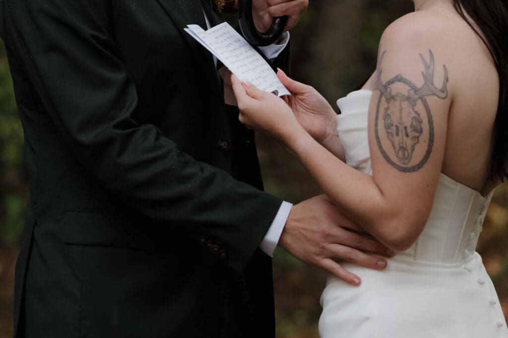 Hayley Zumkeller photography and videography team from Victoria BC captures a bride and groom exchanging private vows in the forest at Church and State Winery in the rain.