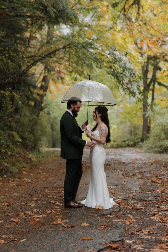 Couple sharing private vows in Vancouver Island forest in the rain surrounded by fall colours