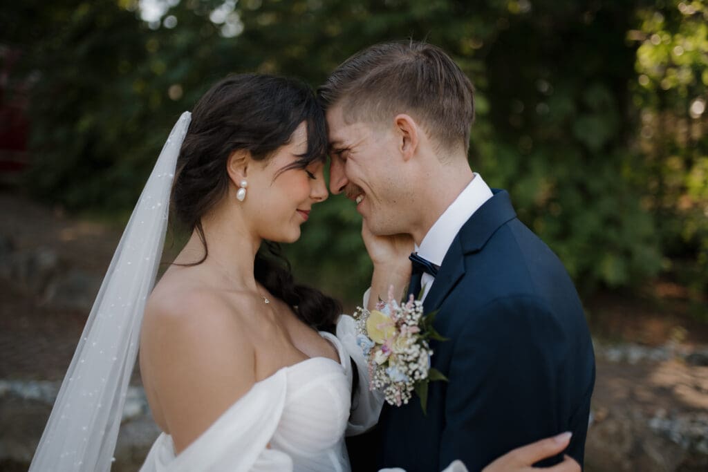 Hayley Zumkeller photography and videography team capture a husband and wife about to kiss following their outdoor wedding on Puska Properties in Nanaimo BC. 