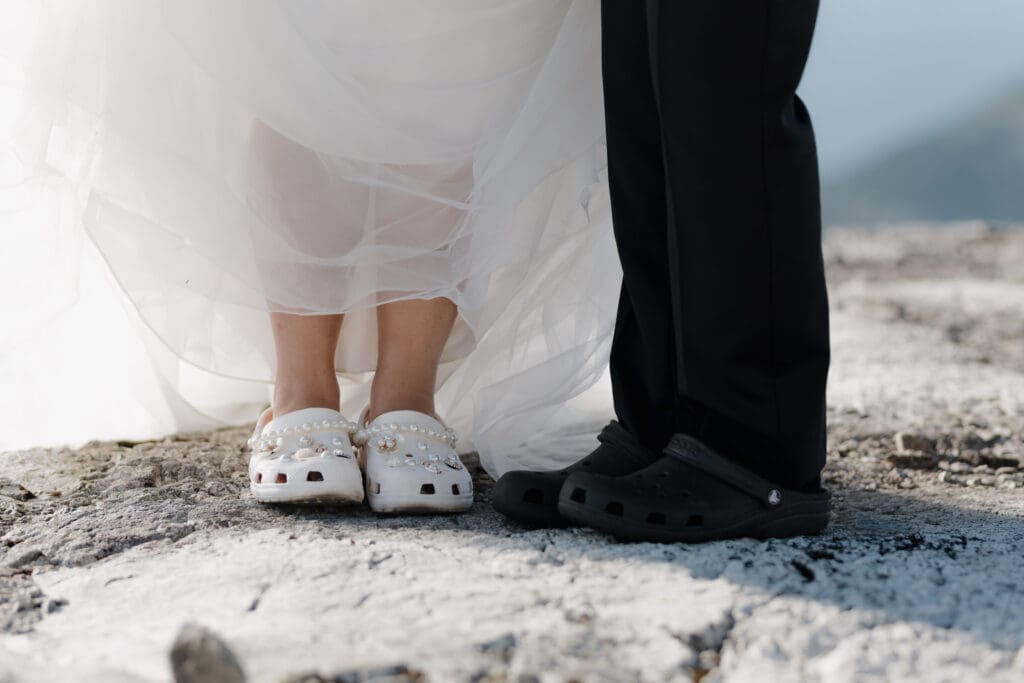 A shot of the bride and groom wearing their crocs during their elegant helicopter elopement. This candid shot was captured by Hayley Zumkeller photography and videography team on Vancouver Island.