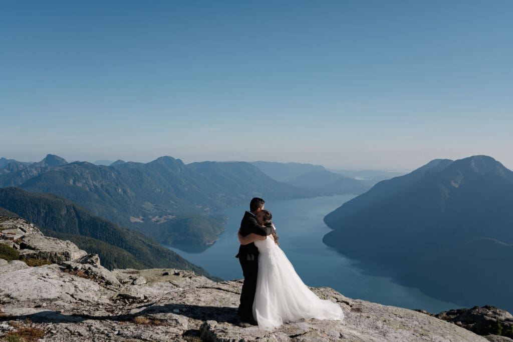 Couple embracing on a mountaintop following their elopement session on Vancouver Island.