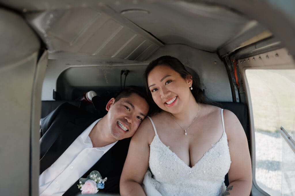 Bride and groom inside helicopter sharing a moment during their Vancouver Island elopement experience