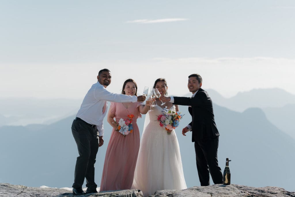 A bride and groom celebrating their mountaintop elopement with their small wedding party on Vancouver Island. Moment captured by Hayley Zumkeller photography and videography team from Victoria BC.