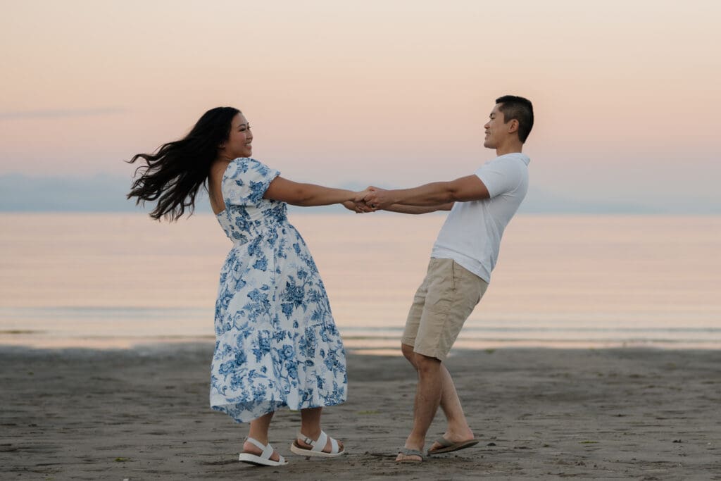 Vancouver Island engagement photographer Hayley Zumkeller captures a playful engagement session with a couple running and connecting along Saratoga Beach during golden hour.