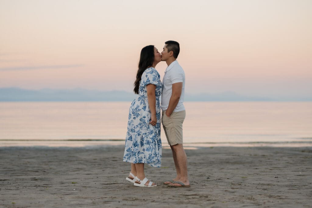Romantic close-up of couple kissing during a Saratoga Beach engagement photography session at sunset on Vancouver Island.