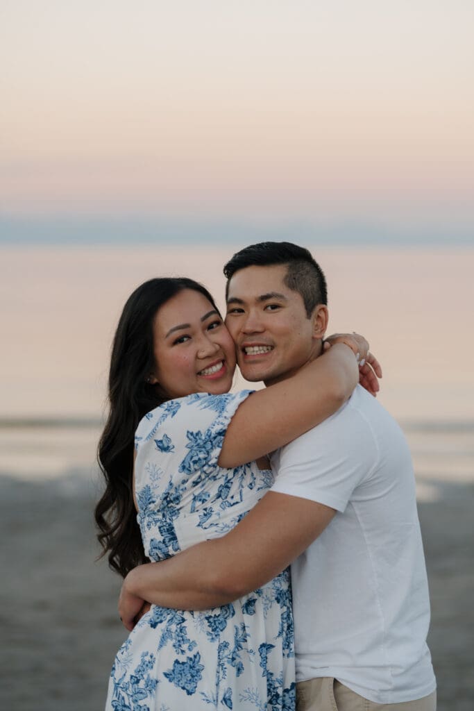 Romantic close-up of couple laughing and embracing during their Saratoga Beach engagement session during golden hour on Vancouver Island. Image captured by Hayley Zumkeller photography and videography team from Victoria BC.